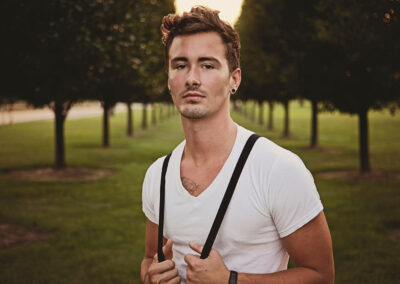Male fashion model with suspenders with vintage feel by Michigan photographer.
